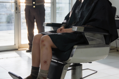 I watched my hair fall to the salon floor as the stylist said, “That should cover the overdraft.”