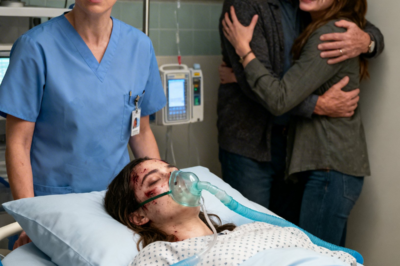 She Died During Childbirth… Her Husband Celebrated. Then the Doctor Said: “There Are Twins.”  The heart monitor screamed.  A sharp, endless sound that sliced through the delivery room like a knife.  Flatline.  A sound that meant only one thing.  Rebecca Moore’s heart had stopped.  After twelve hours of brutal labor, the strongest woman in the room was suddenly silent.  Doctors rushed in.  Nurses shouted commands.  “Code blue!”  “Defibrillator!”  The delivery room erupted into chaos.  Medical carts rolled across the floor.  Machines beeped wildly.  Someone pushed a syringe into Rebecca’s IV.  Another doctor climbed onto the bed, pressing hard on her chest in rhythmic compressions.  But in the corner of the room, there was a strange, unsettling calm.  Three people stood there, watching.